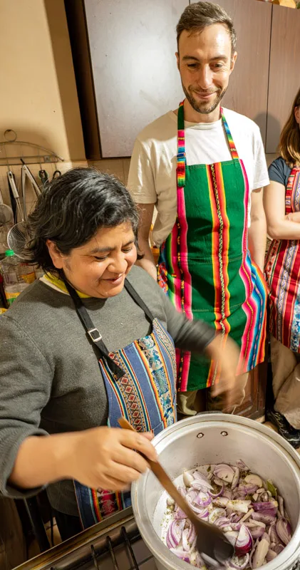 Teacher guiding a student through cooking