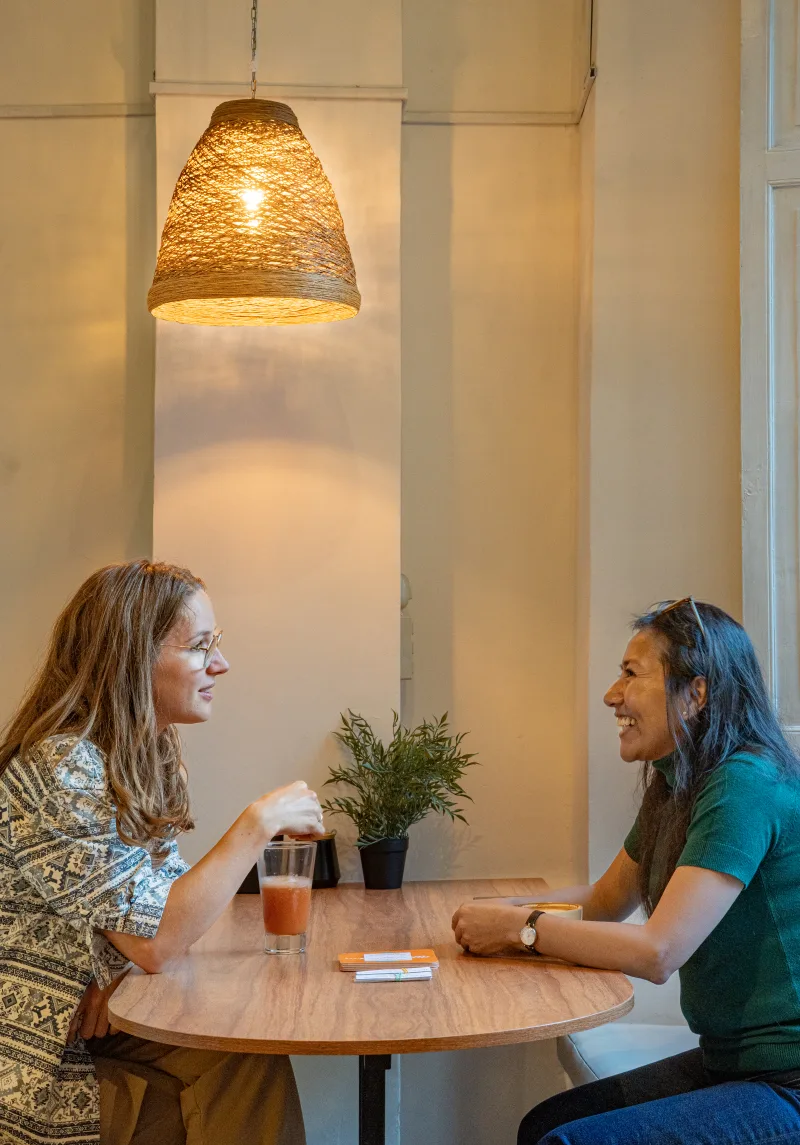 Students and locals chatting around a table during the language exchange
