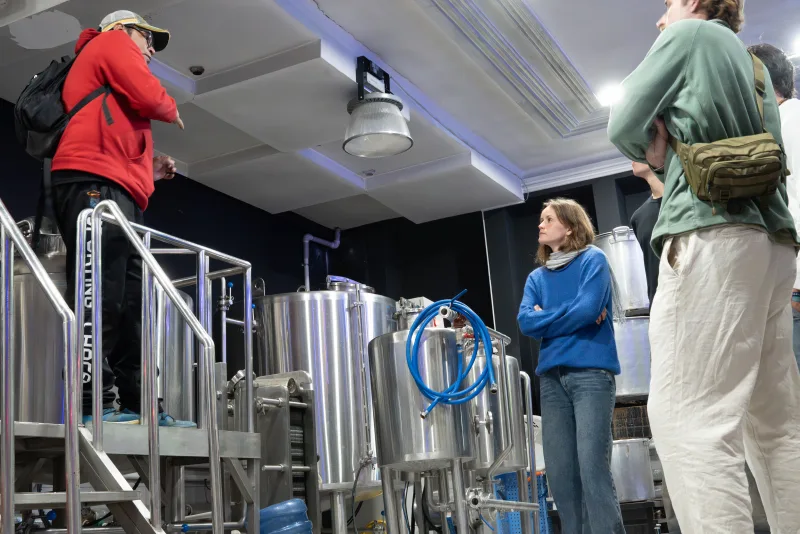 Students listening as the brewer explains the equipment